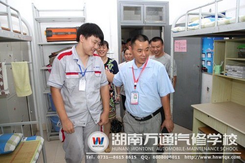 潘助理與家長(zhǎng)代表參觀中專18班宿舍6S成果展